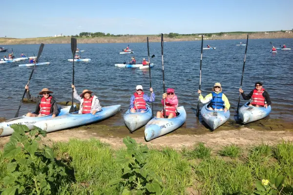 A group of people in canoes on the water.